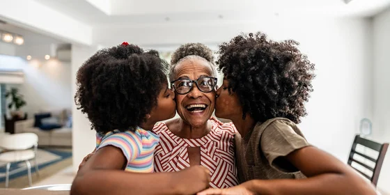 Grandmother kissed by daughter and granddaughter
