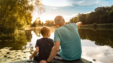 Grandfather and grandson at lake