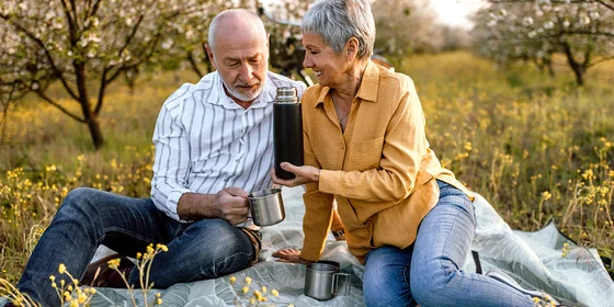 Older couple having a picnic outside