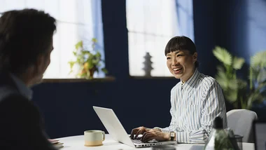 2 people meeting, one has a laptop