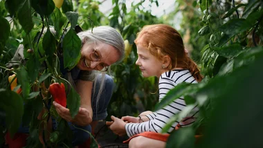 older woman with girl gardening